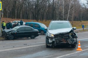 Two damaged cars after a collision on a roadway, illustrating common accident sites caused by negligent driving and heavy traffic